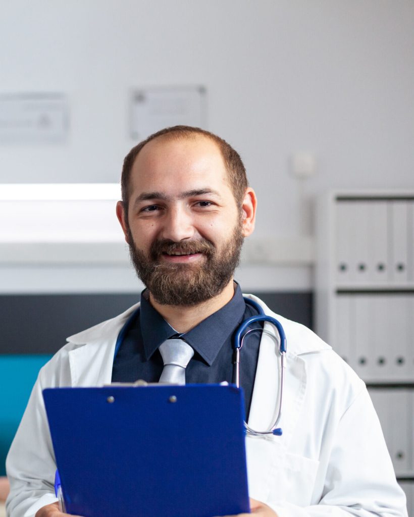 Portrait of orthopedic doctor working to help with recovery. Healthcare specialist looking at camera while preparing for physiotherapy with physical exercise and fitness. Medic at clinic